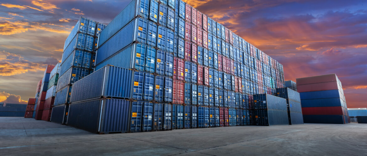 Stacks of cargo containers located on an open area in the open air